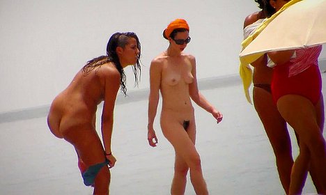 dudes oiling girl beach